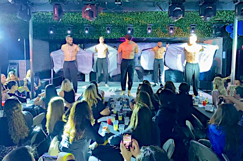 addicted strip act by the hollywood men on stage showing off abs