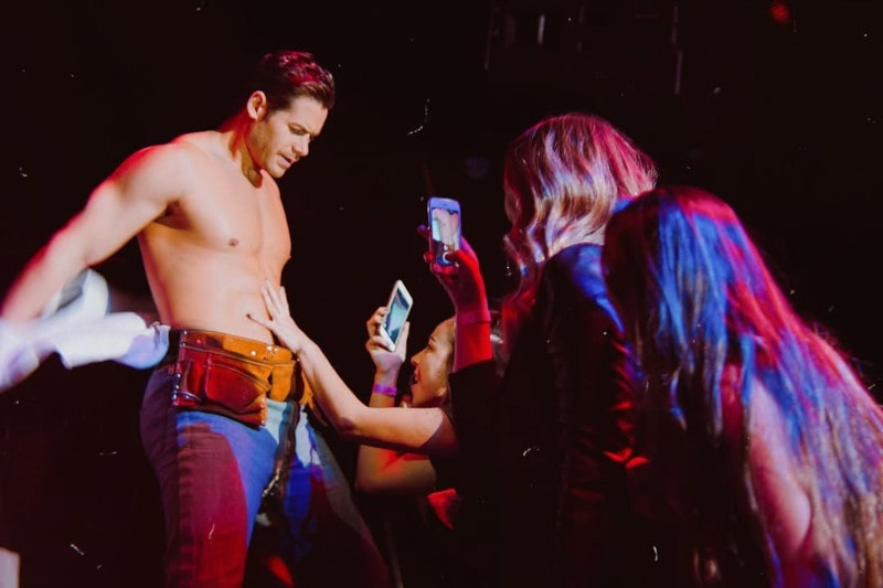 paolo getting tips from ladies on stage during construction strip act